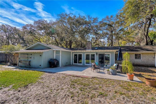 408 Couper Ave, Saint Simons Island, GA 31522 - rear view of property featuring a chimney and a patio