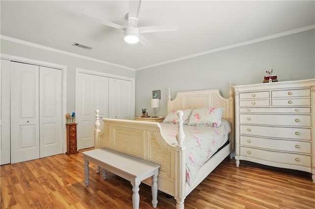 408 Couper Ave, Saint Simons Island, GA 31522 - bedroom with multiple closets, ornamental molding, light wood-style flooring, and a ceiling fan