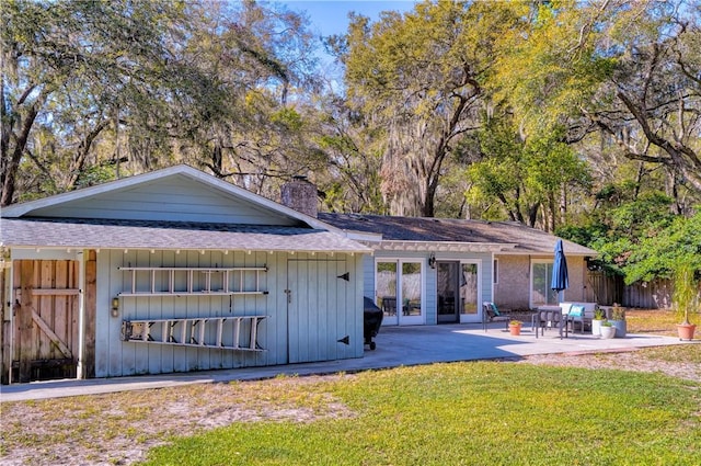 408 Couper Ave, Saint Simons Island, GA 31522 - rear view of property with a patio, a chimney, roof with shingles, and board and batten siding