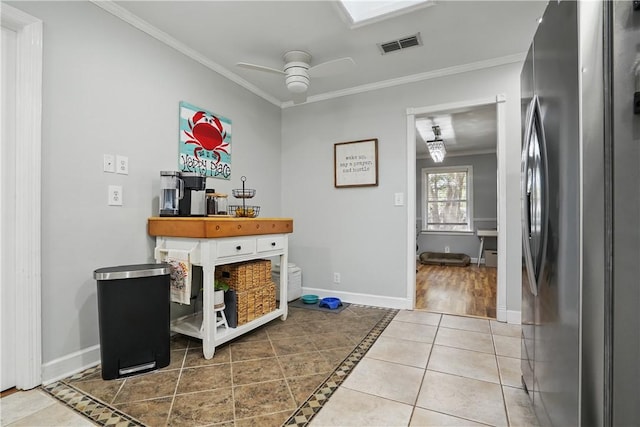 408 Couper Ave, Saint Simons Island, GA 31522 - bar featuring freestanding refrigerator, ornamental molding, a ceiling fan, baseboards, and tile patterned flooring