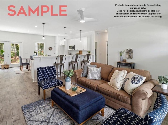 living room featuring hardwood / wood-style floors and ceiling fan