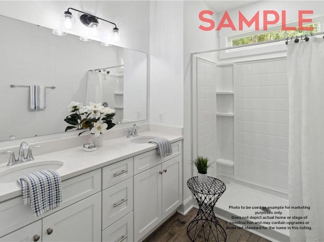 bathroom featuring a shower with shower curtain, vanity, and hardwood / wood-style floors