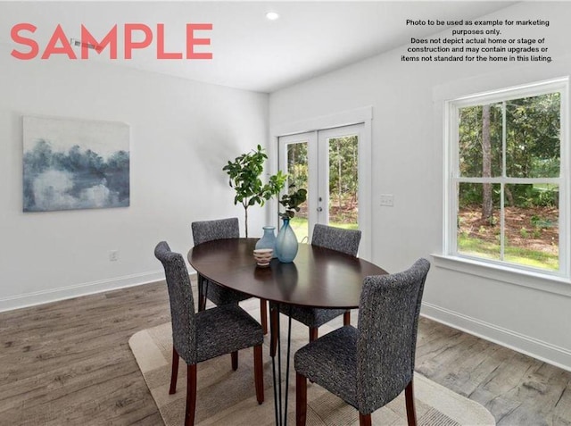 dining room with french doors and hardwood / wood-style floors