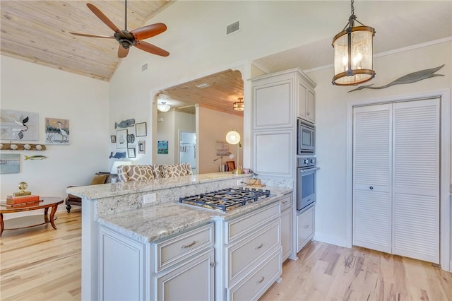 kitchen featuring visible vents, light wood-style floors, appliances with stainless steel finishes, a peninsula, and light stone countertops