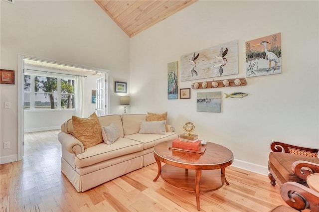 living area with wooden ceiling, baseboards, light wood finished floors, and high vaulted ceiling