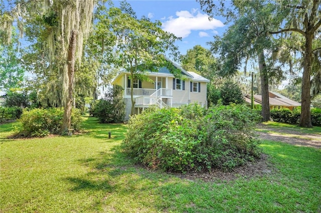 view of yard featuring a porch and stairway