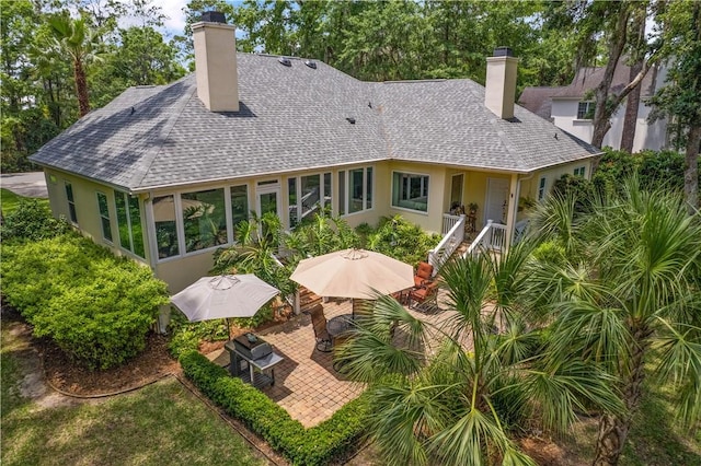 102 Rice Ml, Saint Simons Island, GA 31522 - rear view of property with a chimney, a patio area, roof with shingles, and stucco siding