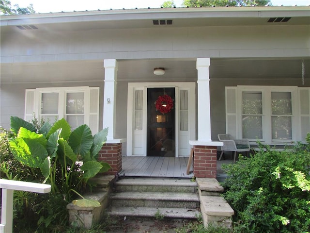 view of exterior entry featuring a porch