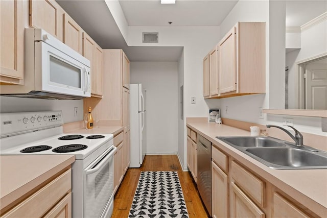 1704 Frederica Rd Unit 508, Saint Simons Island, GA 31522 - kitchen featuring white appliances, light brown cabinets, a sink, light wood-type flooring, and light countertops