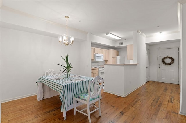 1704 Frederica Rd Unit 508, Saint Simons Island, GA 31522 - dining space featuring a chandelier, light wood finished floors, and baseboards