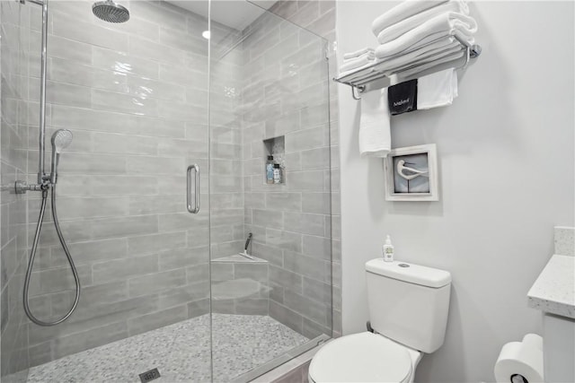 bathroom featuring walk in shower and toilet