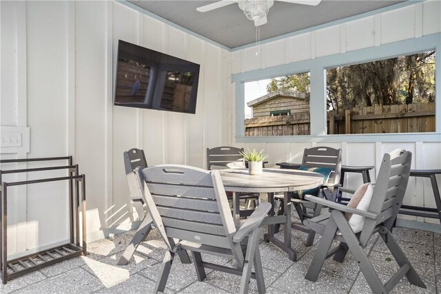 sunroom / solarium featuring ceiling fan