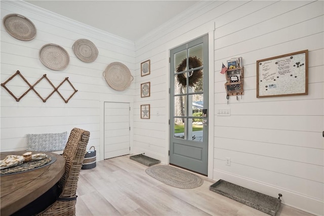 interior space with crown molding and light wood-type flooring