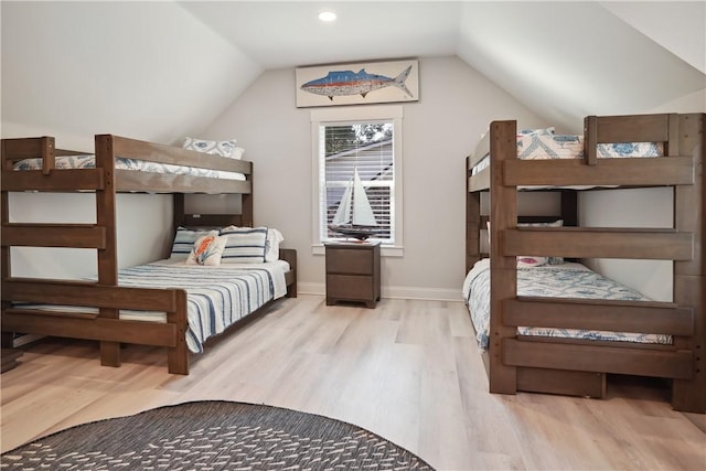 bedroom featuring light hardwood / wood-style flooring and vaulted ceiling