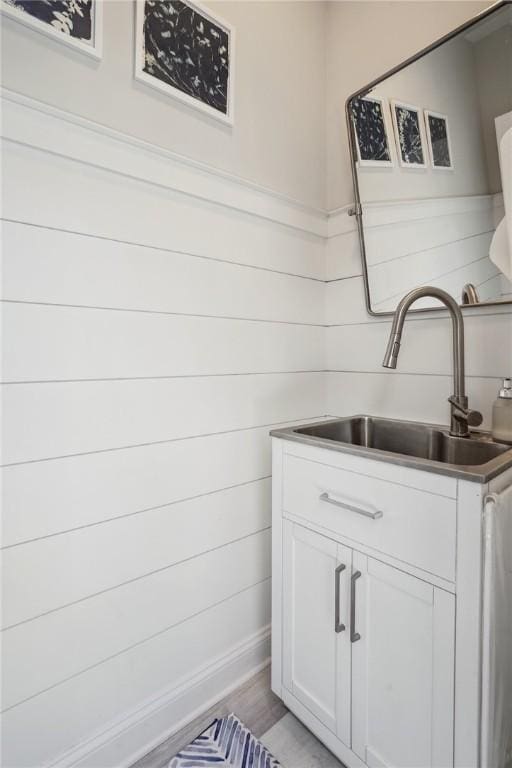 interior space featuring sink, white cabinets, and light hardwood / wood-style floors