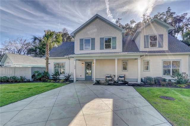 view of front of home with covered porch and a front lawn