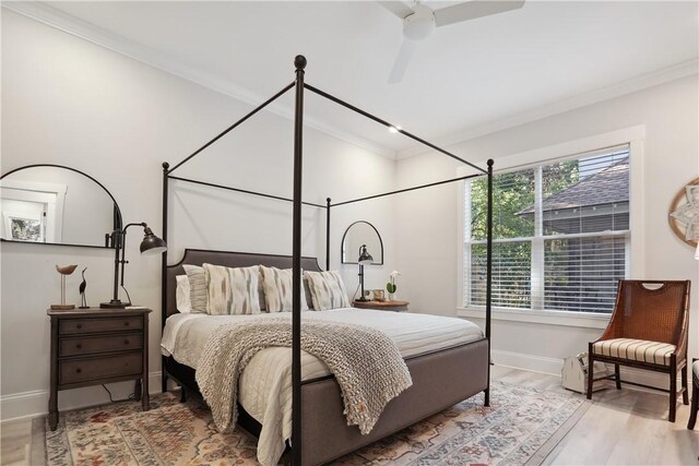 bedroom featuring ceiling fan, ornamental molding, and hardwood / wood-style floors