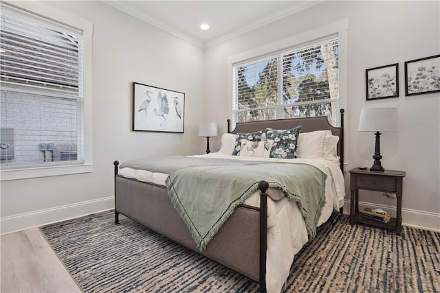 bedroom with crown molding and hardwood / wood-style floors