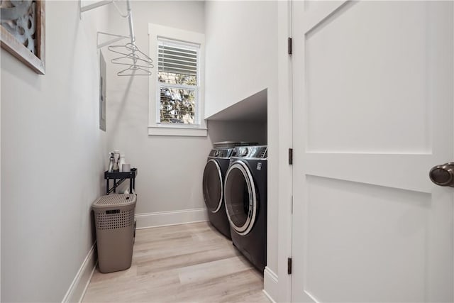 washroom featuring washer and clothes dryer and light hardwood / wood-style floors