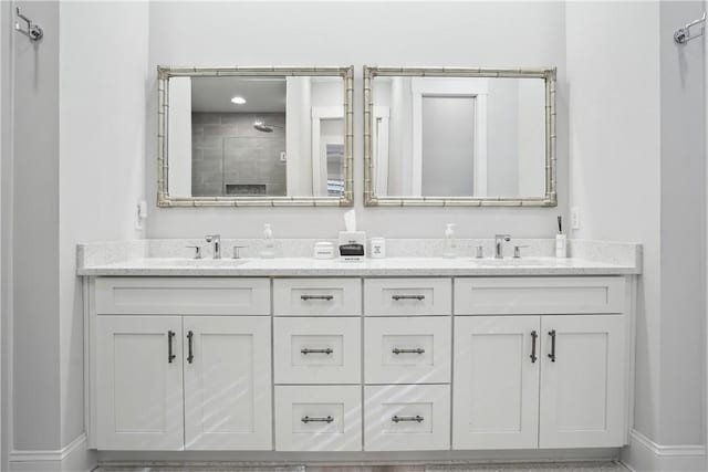 bathroom featuring vanity and tiled shower