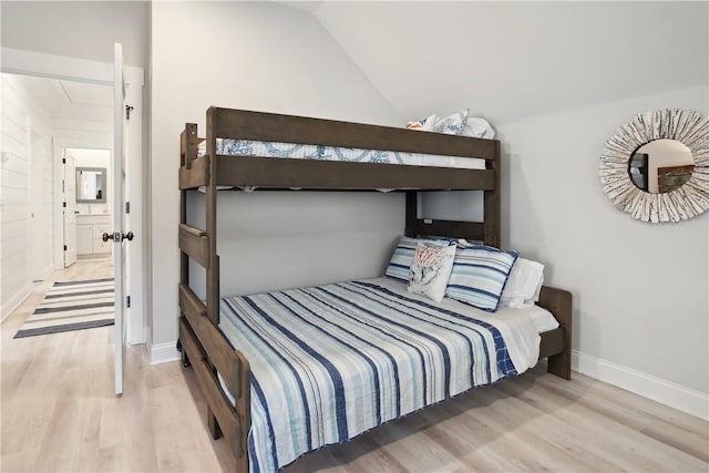 bedroom featuring lofted ceiling and light hardwood / wood-style flooring