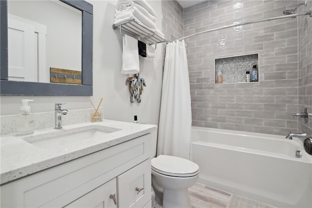 full bathroom featuring shower / tub combo, vanity, and toilet