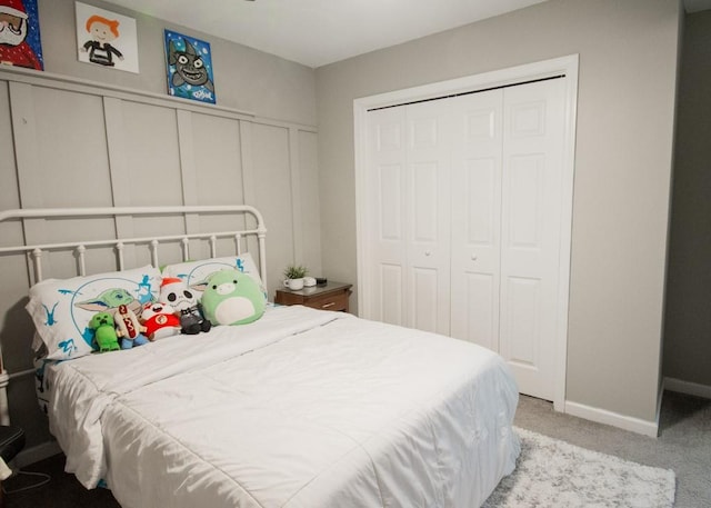 bedroom with light carpet and a closet