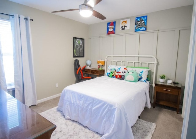 bedroom with multiple windows, light carpet, and ceiling fan