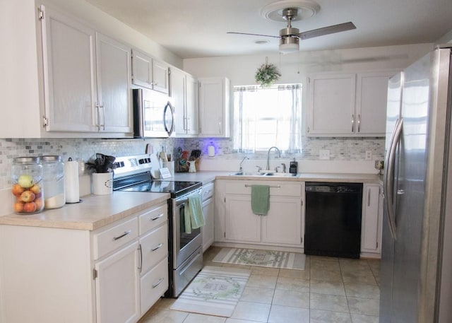 kitchen with sink, ceiling fan, appliances with stainless steel finishes, tasteful backsplash, and white cabinets