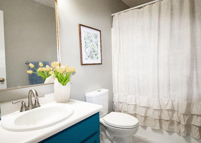 full bathroom with vanity, shower / tub combo, and toilet