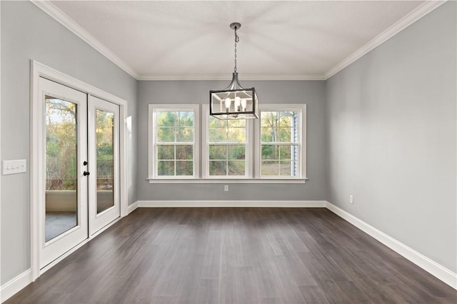 unfurnished dining area featuring a chandelier, french doors, dark hardwood / wood-style flooring, and ornamental molding