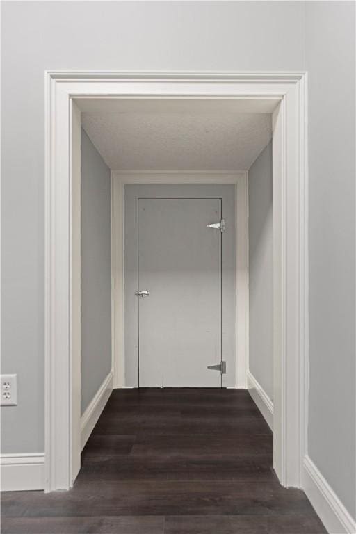 corridor featuring dark hardwood / wood-style floors