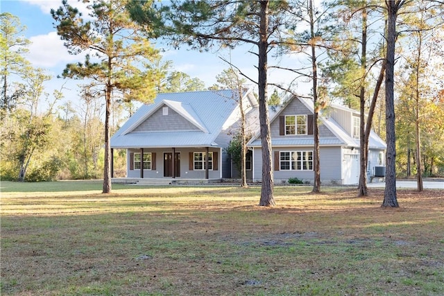 view of front of property featuring central air condition unit, a front lawn, and covered porch