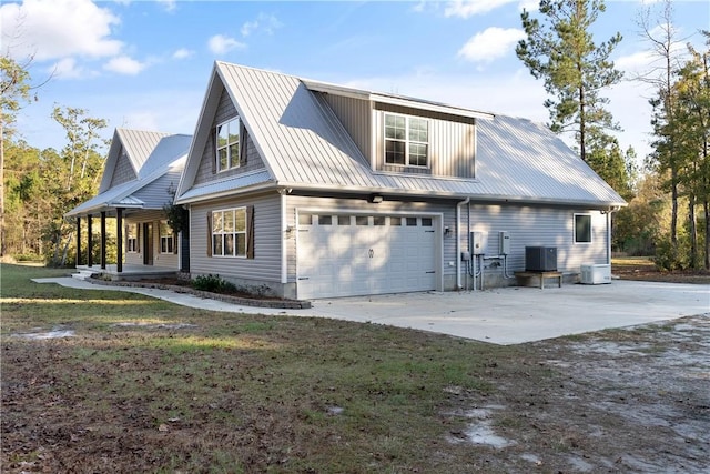 back of house featuring a garage and central AC