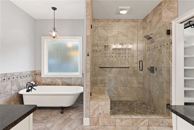 bathroom featuring vanity, tile walls, and independent shower and bath