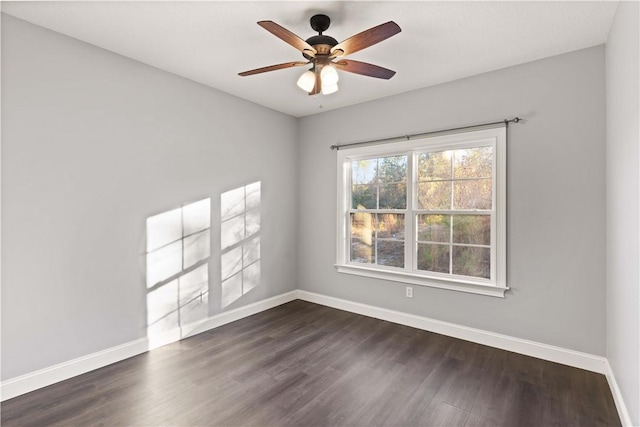 empty room with dark hardwood / wood-style floors and ceiling fan