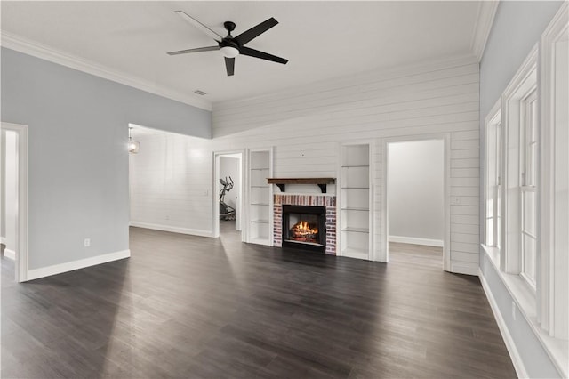 unfurnished living room with ceiling fan, crown molding, dark hardwood / wood-style floors, and a brick fireplace