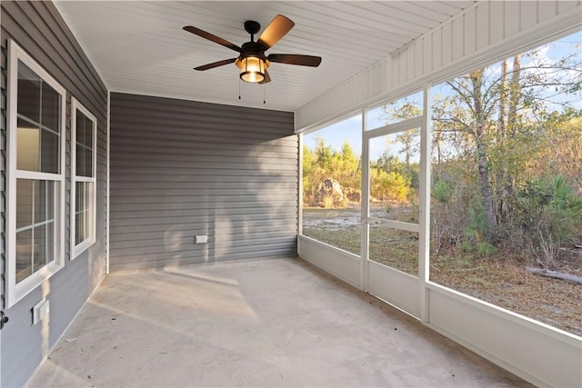 unfurnished sunroom with ceiling fan