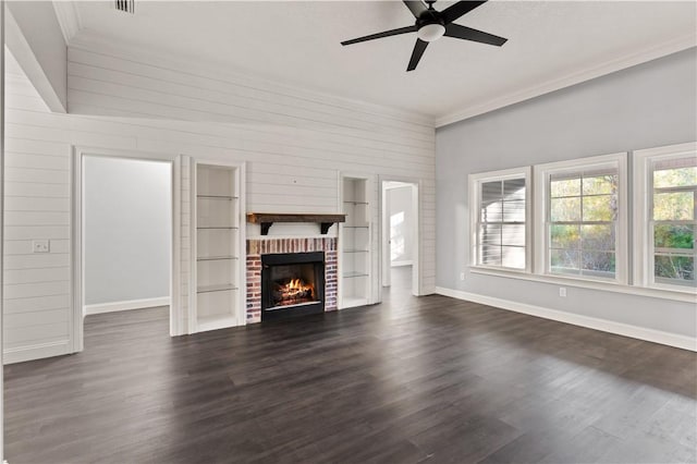 unfurnished living room featuring ceiling fan, a fireplace, crown molding, and dark hardwood / wood-style floors