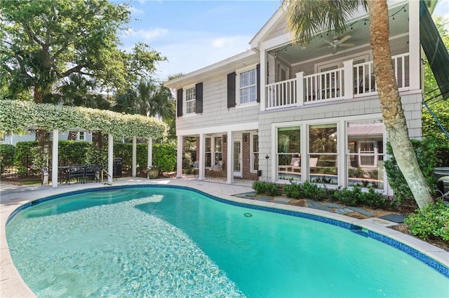pool with a patio and a ceiling fan