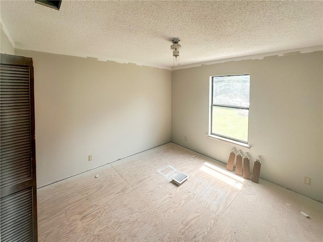 47 Marsh View Ct, Saint Marys, GA 31558 - empty room with a textured ceiling and wood finished floors