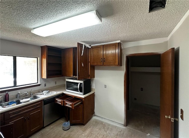 47 Marsh View Ct, Saint Marys, GA 31558 - kitchen featuring appliances with stainless steel finishes, a textured ceiling, a sink, light countertops, and open shelves
