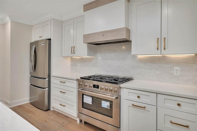 kitchen with appliances with stainless steel finishes, light countertops, custom range hood, and crown molding