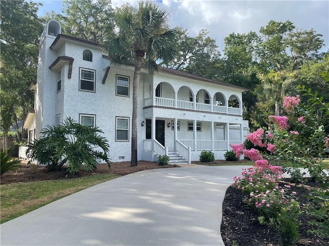 mediterranean / spanish-style home featuring covered porch and a balcony