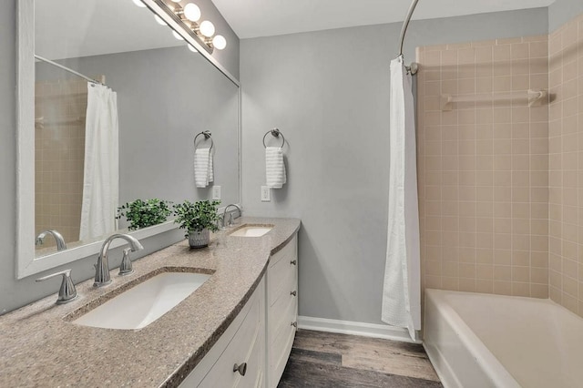 bathroom with shower / bath combo with shower curtain, vanity, and wood-type flooring