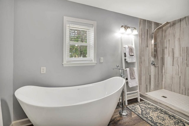 bathroom with shower with separate bathtub and hardwood / wood-style floors