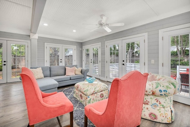 sunroom featuring french doors, a wealth of natural light, and ceiling fan