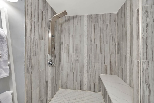 bathroom with tiled shower