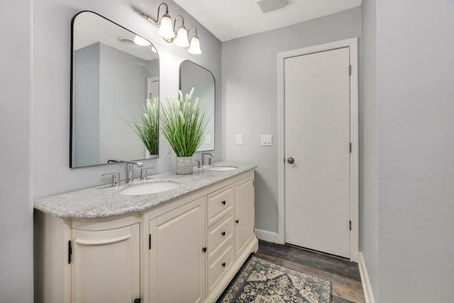 bathroom with vanity and wood-type flooring