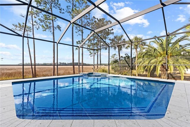 view of swimming pool with an in ground hot tub and glass enclosure